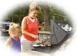 Lady and girl grilling